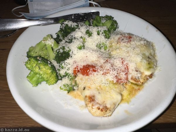 Grilled Chicken Margherita<br>Topped with freshly chopped tomatoes, mozzarella, basil pesto and lemon garlic sauce.  Served with parmesan garlic broccoli