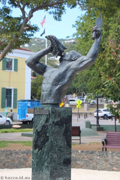 A bronze statue of a freed slave blowing a conch shell, in Emancipation Garden