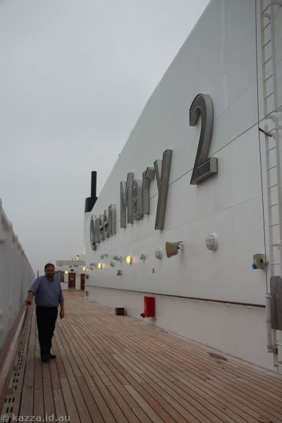 Stu next to the Queen Mary 2 sign, deck 12