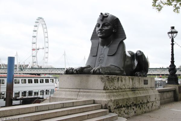 Egyptian style sphinx next to Cleopatra's Needle and London Eye