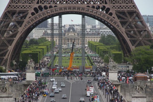 View through the base of the Eiffel Tower along Champ de Mars