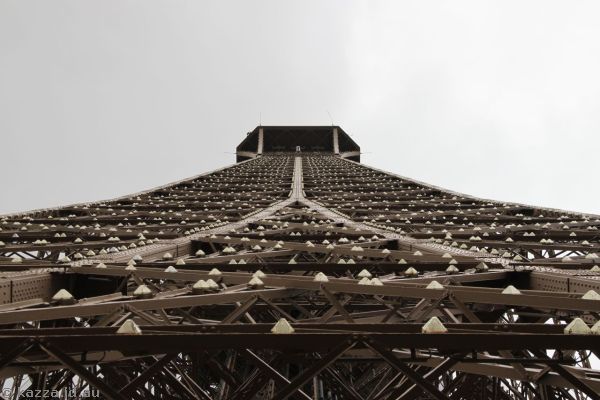 Looking up to the top of the Eiffel Tower from the second level