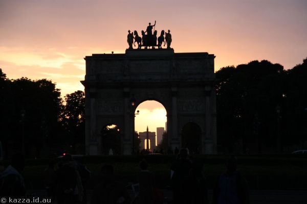 View through the Arc de Triomphe du Carrousel to the obelisk and Arc de Triomphe at sunset