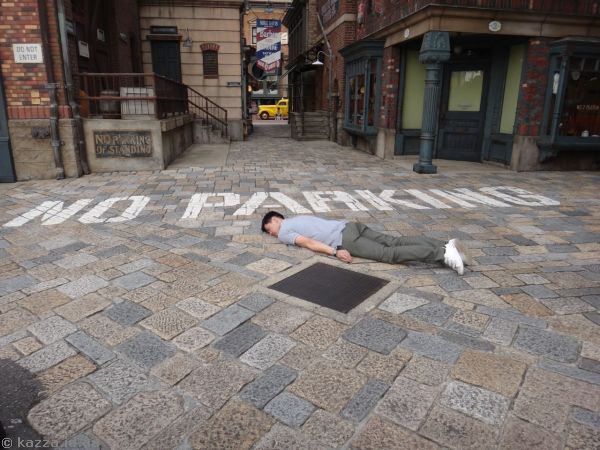 Guy planking next to a no parking sign