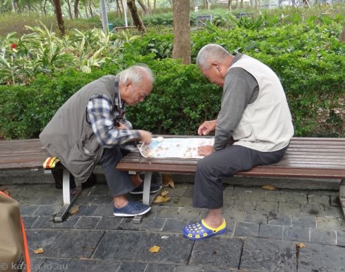 Two old Chinese guys playing Chinese Chess