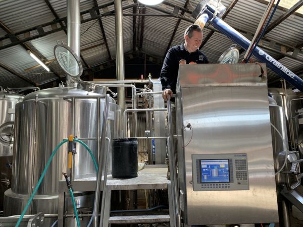 Tumut River Brewing Co (TRBC) Tim inspects the processing tank