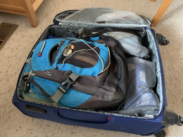 Packed suitcase including backpack