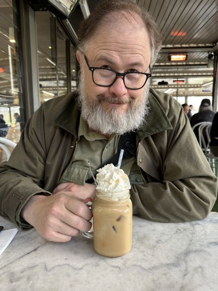 Stu with his iced coffee at the botanical gardens