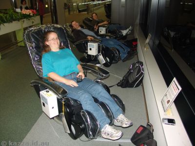Relaxing in the massage chairs at the airport