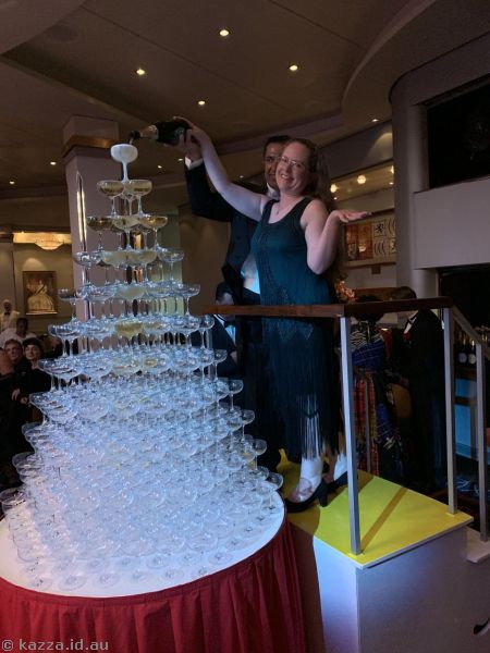 Kaz pouring champagne into the champagne tower