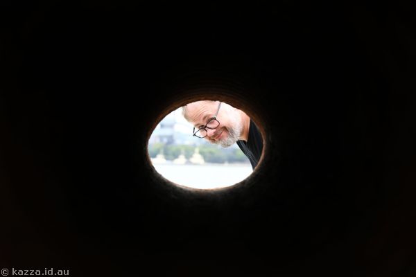 Stu looking through a hole in a concrete block on the breakwater