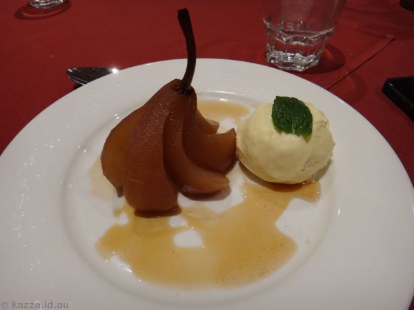 Red wine and cinnamon poach pear with vanilla ice cream and roasted nuts