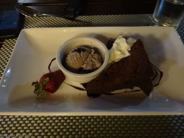 Snickers bar brownie served with chocolate sauce and whipped cream