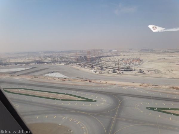 Taking off from Abu Dhabi airport with a view to the new terminal under construction