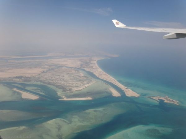 Sandy coastline and view towards Abu Dhabi city